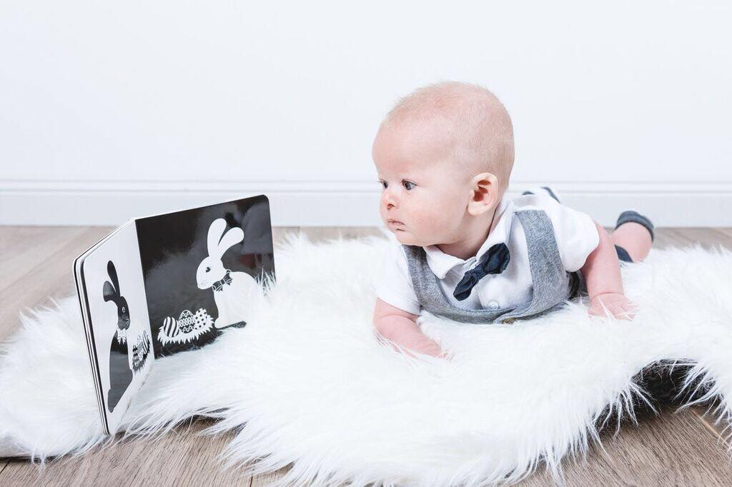 Baby looking at black and white board book