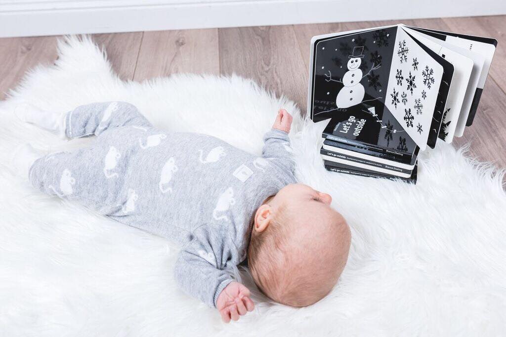 Baby looking at black and white developmental book for newborns and babies